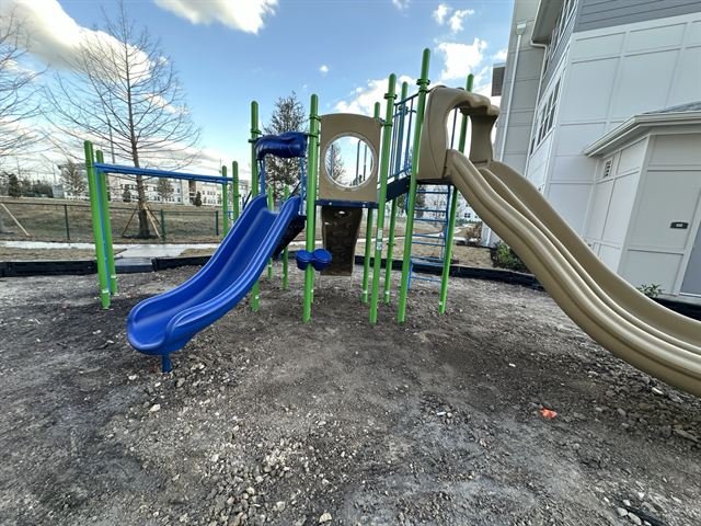 Playground equipment installation in progress at a residential community site.
