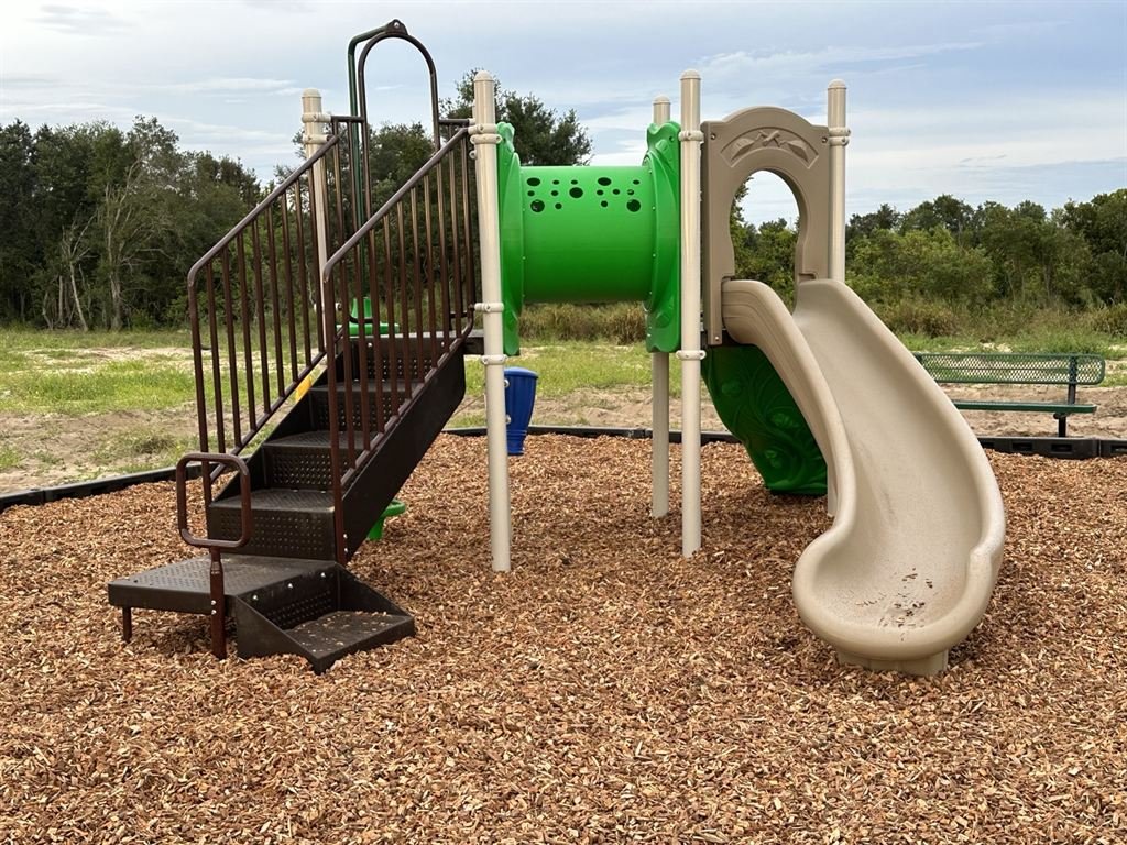 Accessible playground equipment installation with ramp access.